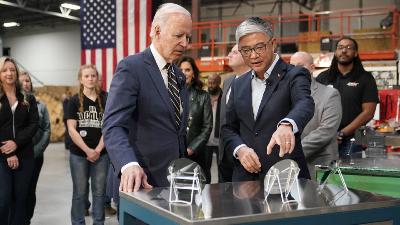 President Joe Biden tours SK Siltron CSS, a computer chip factory in Bay City, Mich., Tuesday, Nov. 29, 2022, with SK Siltron CSS CEO Jianwei Dong. (AP Photo/Patrick Semansky)