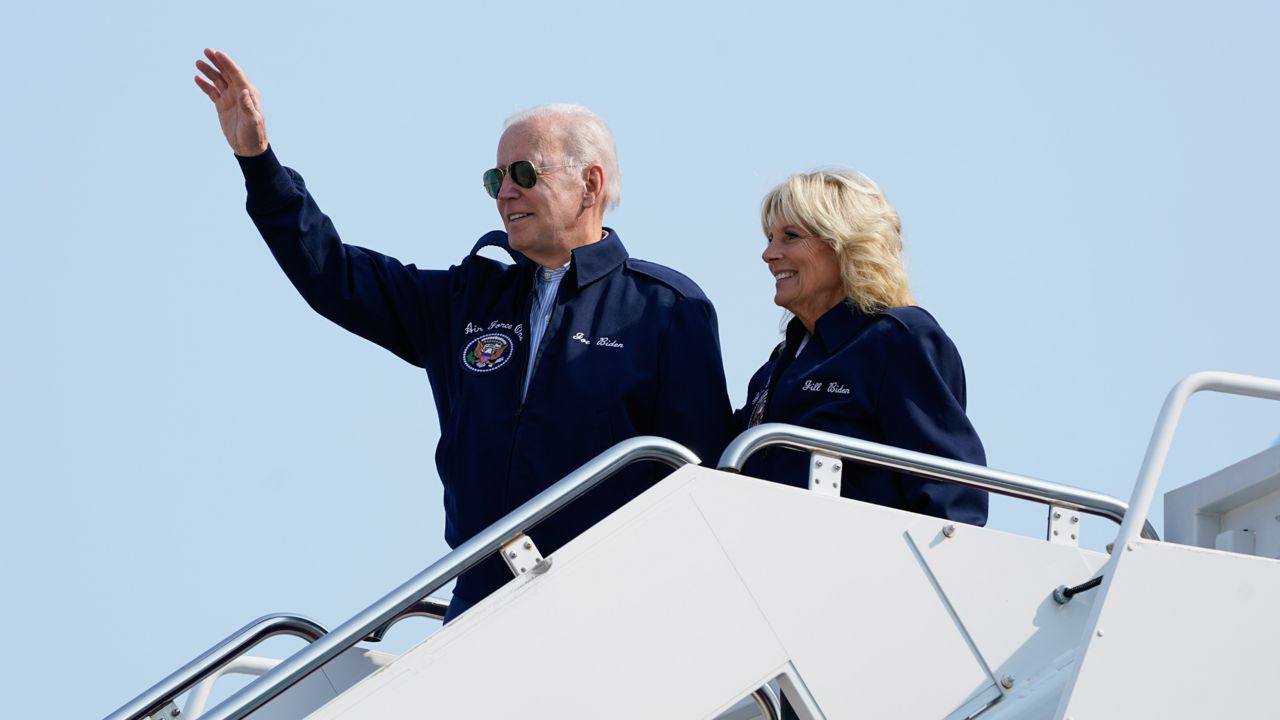 President Joe Biden waves as he stands at the top of the steps of Air Force One before boarding with first lady Jill Biden at Andrews Air Force Base, Md., Saturday, Sept. 17, 2022, as they head to London to attend the funeral for Queen Elizabeth II. To commemorate the U.S. Air Force’s 75th anniversary as a service, the Bidens are wearing Air Force One jackets. (AP Photo/Susan Walsh)
