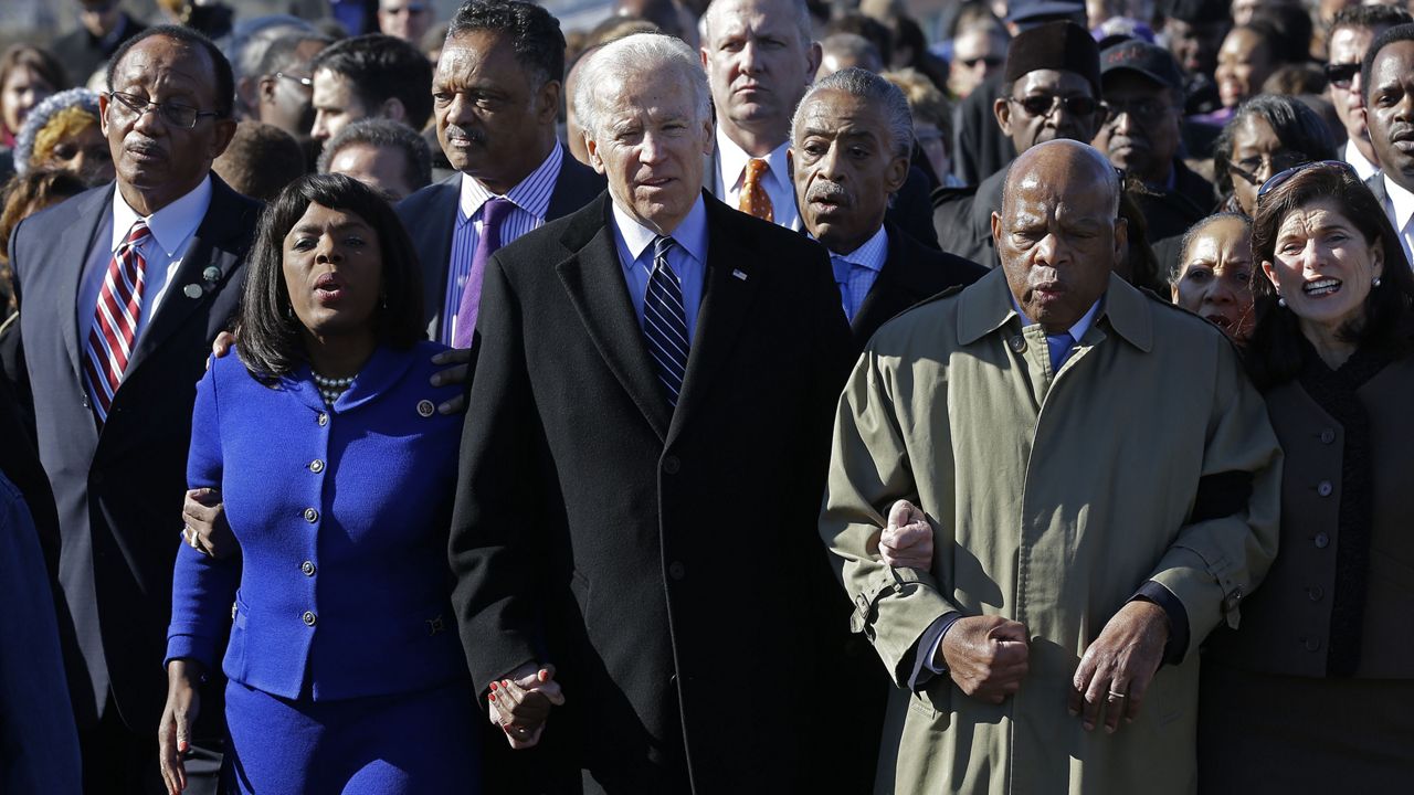 FILE PHOTO: Then-Vice President Joe Biden, center, leads a group across the Edmund Pettus Bridge in Selma, Ala., Sunday, March 3, 2013. (AP Photo/Dave Martin)