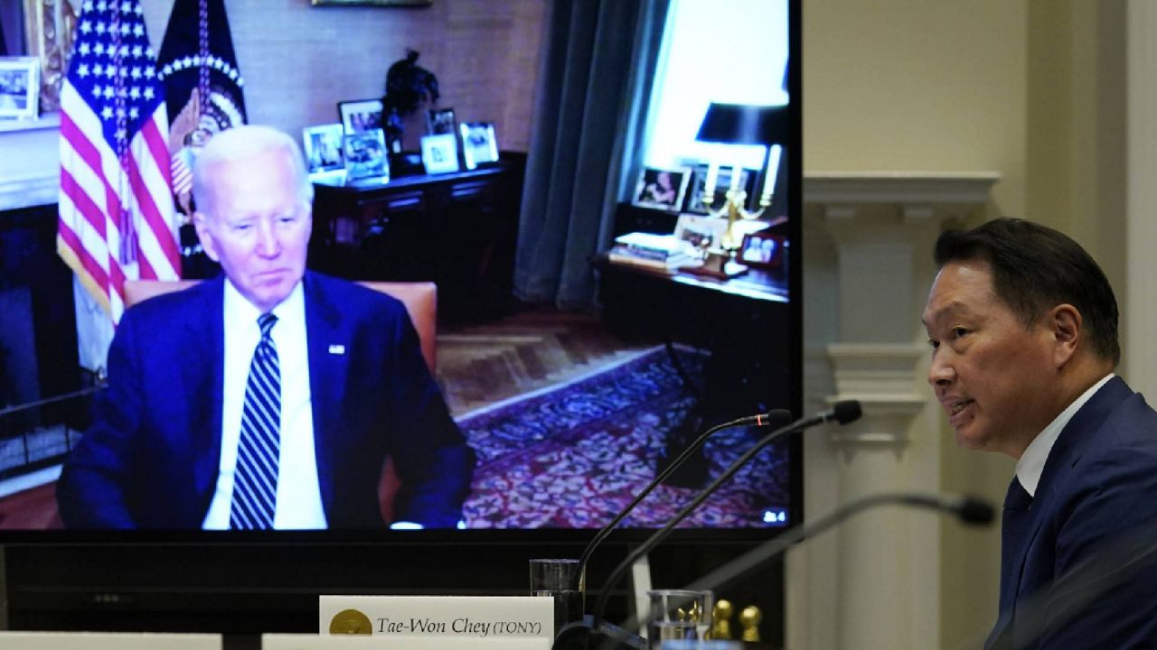 President Joe Biden, on screen at left, listens as SK Group Chairman Chey Tae-won, right, speaks from the Roosevelt Room of the White House in Washington, Tuesday, July 26, 2022. The meeting comes as the Biden administration is seeking the cooperation of Asian allies such as South Korea to reinforce supply chains for critical components such as semiconductors. (AP Photo/Susan Walsh)