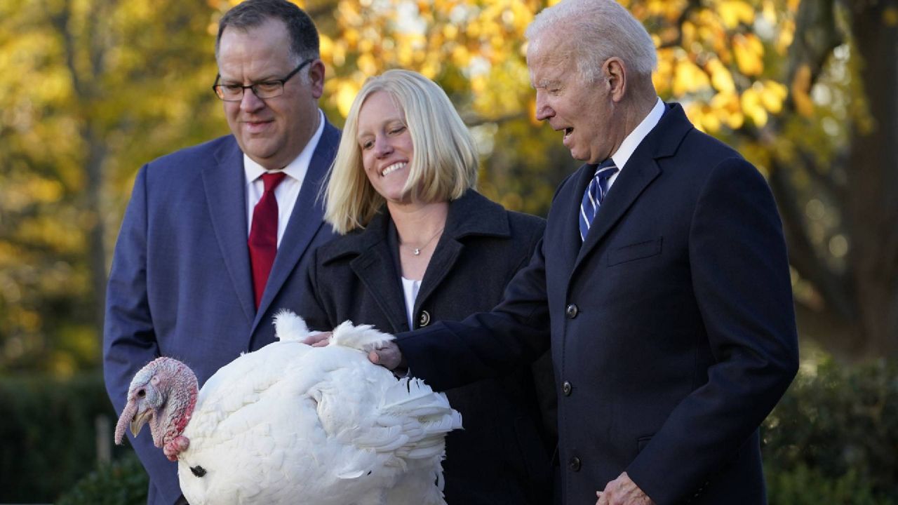 President Joe Biden pardons Peanut Butter, the national Thanksgiving turkey, during a ceremony in the Rose Garden of the White House in Washington, Friday, Nov. 19, 2021. Biden is joined by, from left, Phil Seger, Chairman of the National Turkey Federation, and Andrea Welp, turkey grower from Indiana. (AP Photo/Susan Walsh)