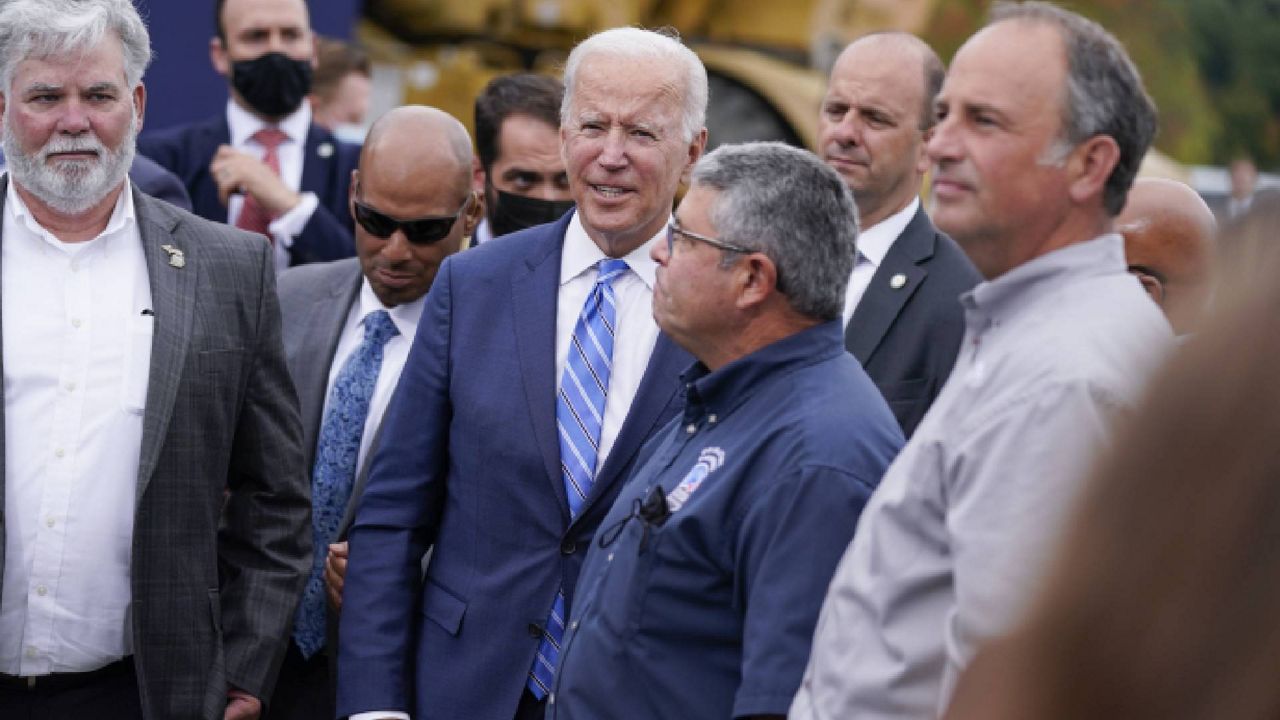 President Joe Biden greets people after delivering remarks on his "Build Back Better" agenda during a visit to the International Union Of Operating Engineers Local 324, Tuesday, Oct. 5, 2021, in Howell, Mich. He stands with Training Director John Osika. (AP Photo/Evan Vucci)