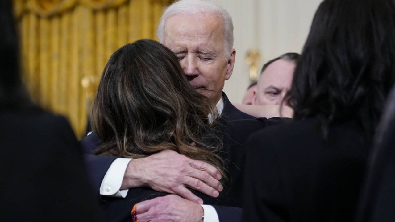 President Joe Biden hugs Kathy Sherlock, mother of Kayden Mancuso, a 7-year-old who was killed, after Biden spoke at an event to celebrate the reauthorization of the Violence Against Women Act in the East Room of the White House, Wednesday, March 16, 2022, in Washington. Kayden's biological father Jeffrey Mancuso killed the young girl inside his Philadelphia home before taking his own life. (AP Photo/Patrick Semansky)