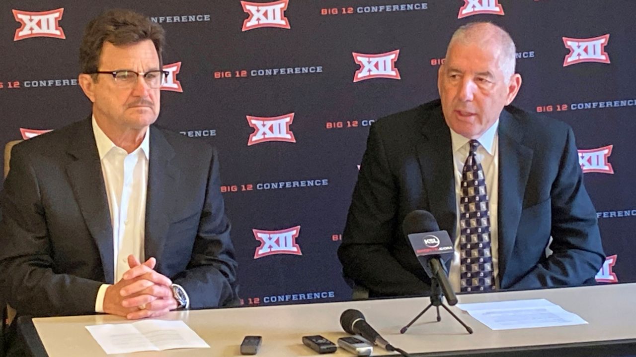 Big 12 commissioner Bob Bowlsby, right, and Texas Tech president Lawrence Schovanec, chairman of the Big 12 board of directors, talk with media at the end of the conference's annual spring meetings, Friday, June 3, 2022, in Irving, Texas. The Big 12 is distributing a record $426 million to its 10 schools for the 2021-22 academic year, and expects to have a new commissioner in place by mid-July. Bowlsby is retiring. (AP Photo/Stephen Hawkins).
