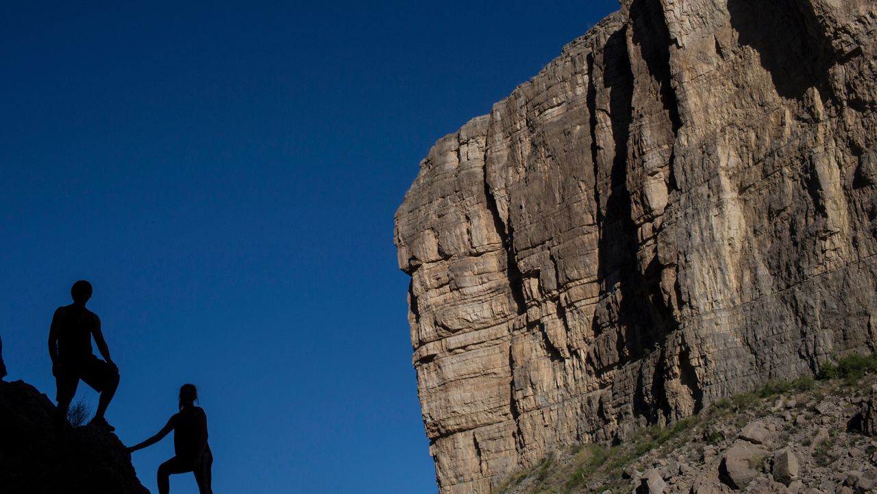 Tourists pose for photos in in Big Bend National Park in Texas. (AP Photo/Rodrigo Abd)