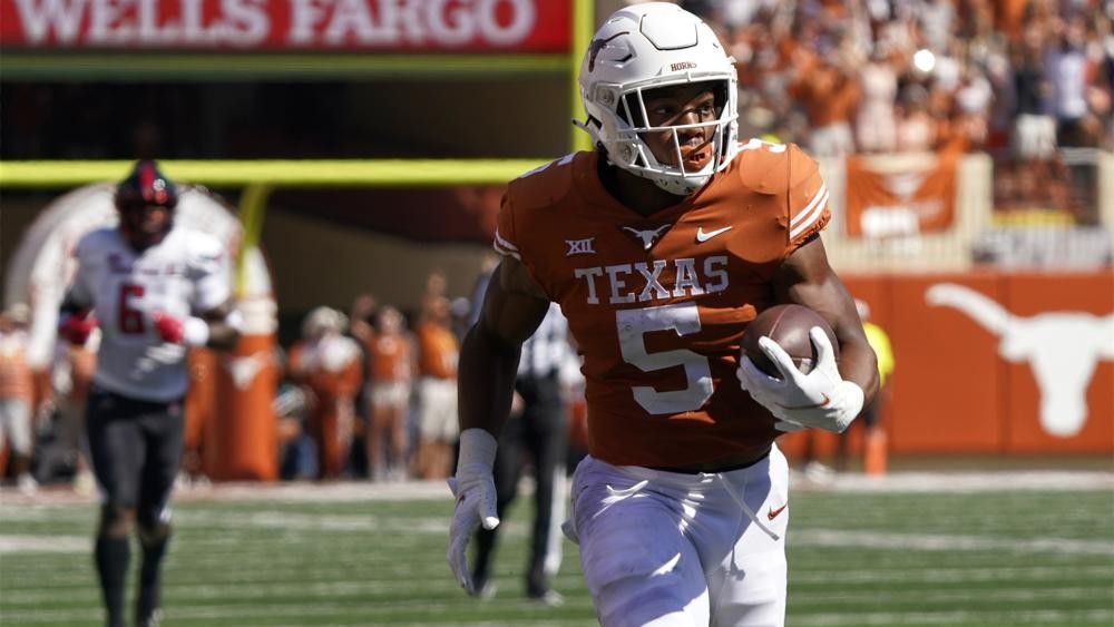 Texas running back Bijan Robinson (5) runs for a touchdown against Texas Tech during the first half of an NCAA college football game on Saturday, Sept. 25, 2021, in Austin, Texas. (AP Photo/Chuck Burton)