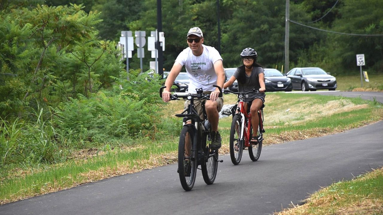 Cyclists enjoy a stretch of the Ohio River West Trail, one of the bike trails that aims to connect downtown to Cincinnati's West Side