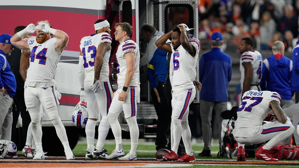Bills players are visibly distressed on the field as their teammate receives potentially life-saving medical treatment. (AP)