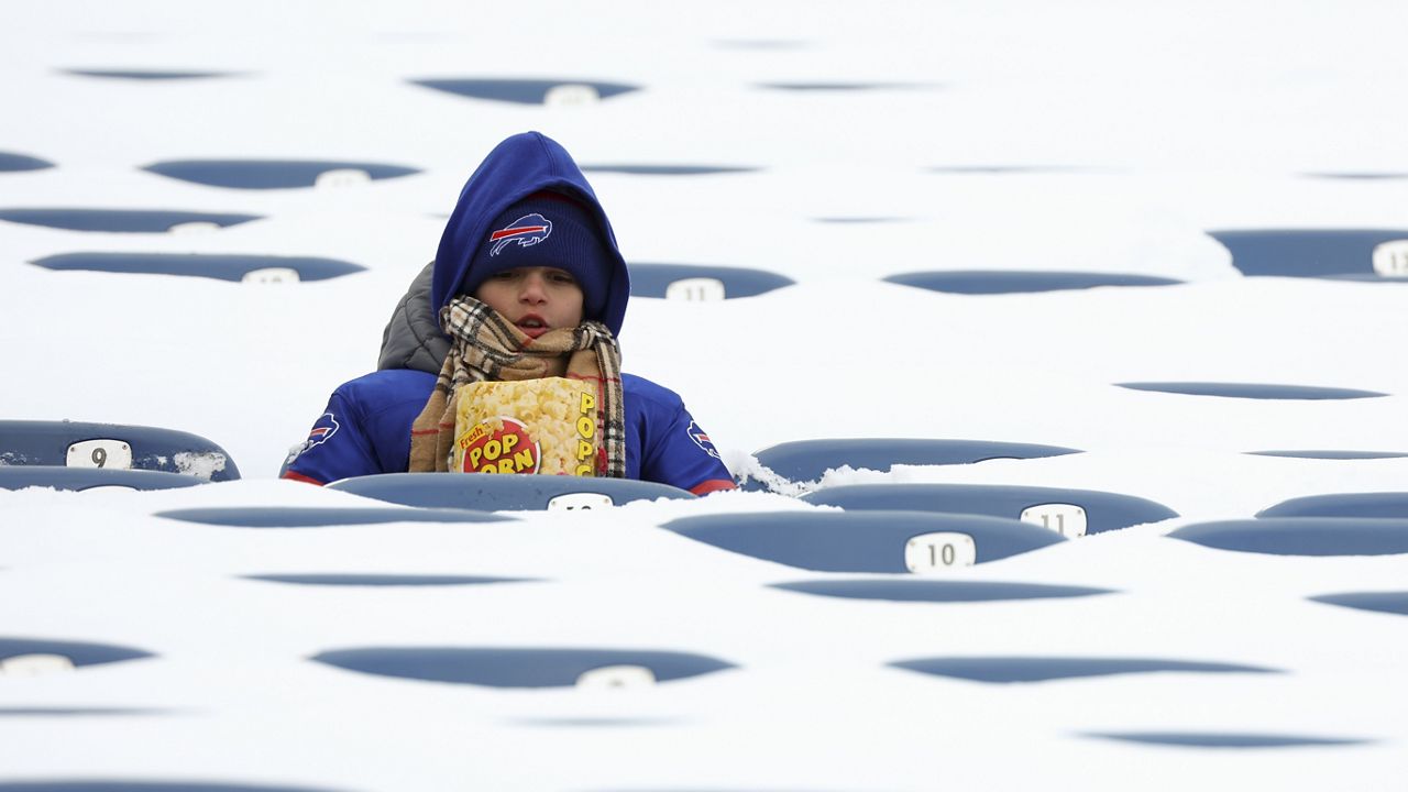 In this photo from last January, a Buffalo Bills fan sits amongst snow covered seats while waiting for the start an NFL wild-card playoff football game between the Buffalo Bills and the Pittsburgh Steelers, Jan. 15, 2024, in Buffalo, N.Y. (AP Photo/Jeffrey T. Barnes, File)