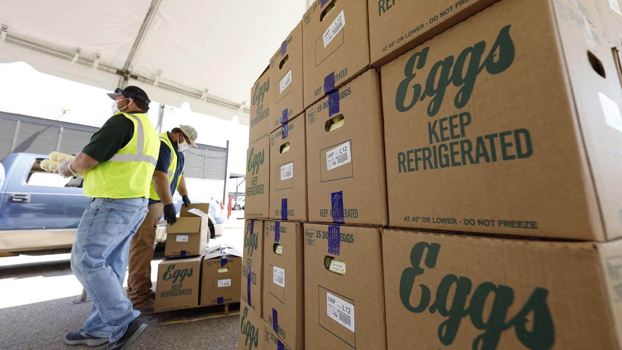 Cases of eggs from Cal-Maine Foods, Inc., await to be handed out by the Mississippi Department of Agriculture and Commerce employees at the Mississippi State Fairgrounds in Jackson, Miss., on Aug. 7, 2020. (AP Photo/Rogelio V. Solis, file)