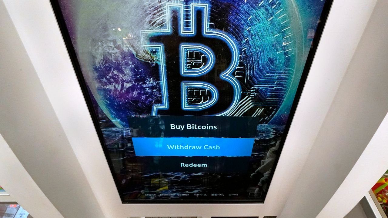 FILE - In this Feb. 9, 2021, file photo, the Bitcoin logo appears on the display screen of a cryptocurrency ATM at the Smoker's Choice store in Salem, N.H. (AP Photo/Charles Krupa, File)
