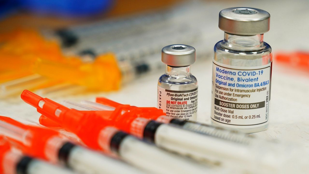 Pfizer, left, and Moderna bivalent COVID-19 vaccines are readied for use at a clinic in Richmond. Va., on Nov. 17. (AP Photo/Steve Helber, File)