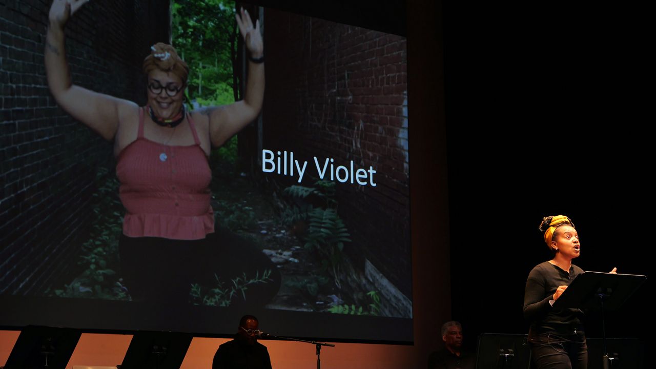 Woman talks on a stage