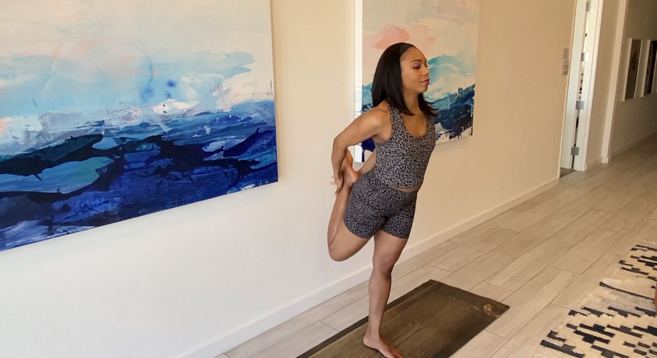 A woman holds a yoga pose. (Bria Bell/Spectrum news 1)