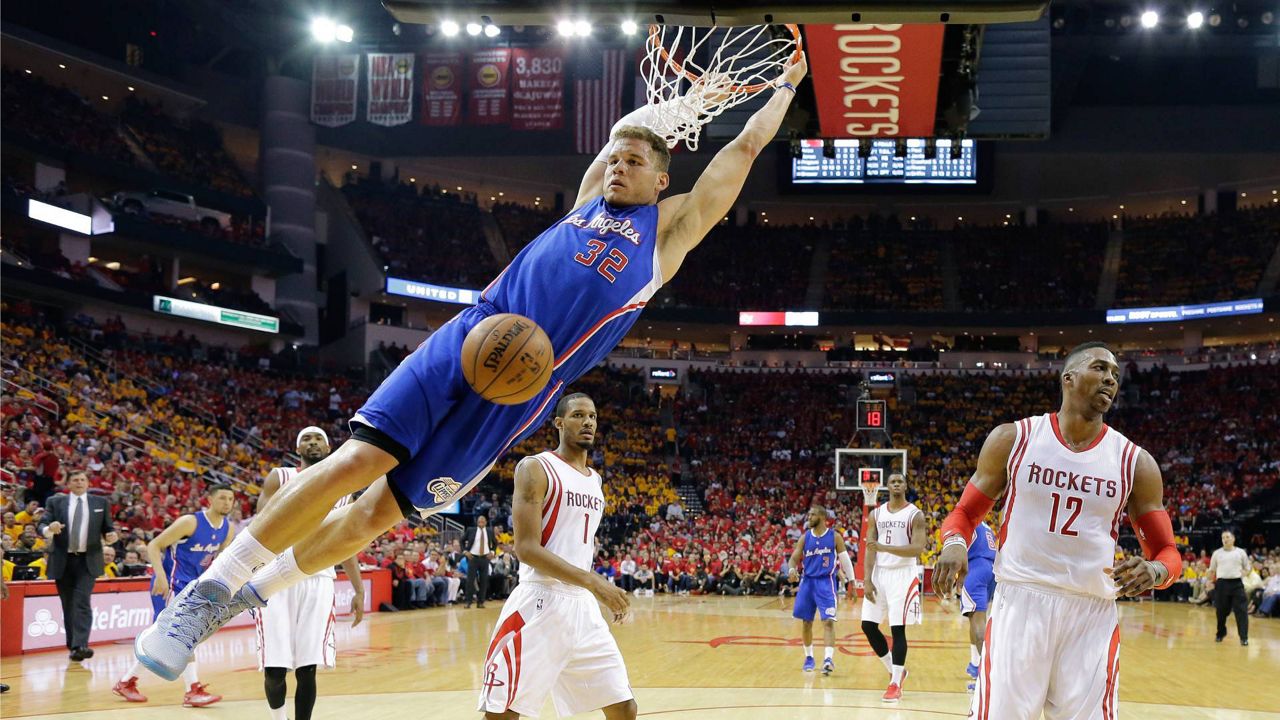 Los Angeles Clippers' Blake Griffin (32) scores past Houston Rockets' Dwight Howard (12) and Trevor Ariza (1) during the second half in Game 5 of the NBA basketball Western Conference semifinals, May 12, 2015, in Houston. (AP Photo/David J. Phillip)