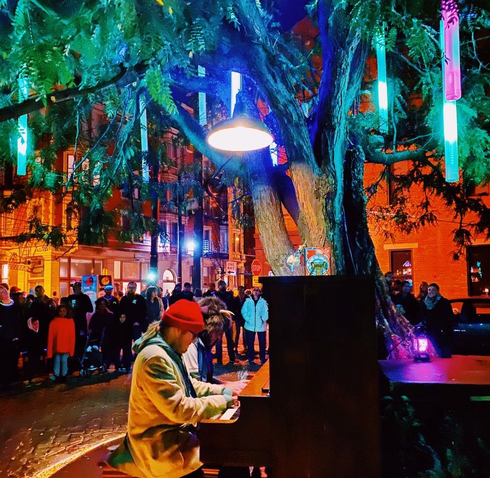 A photo of a person playing a piano as part of an art installation during BLINK 2019. (Photo courtesy of Kyle Eli Ebersole)