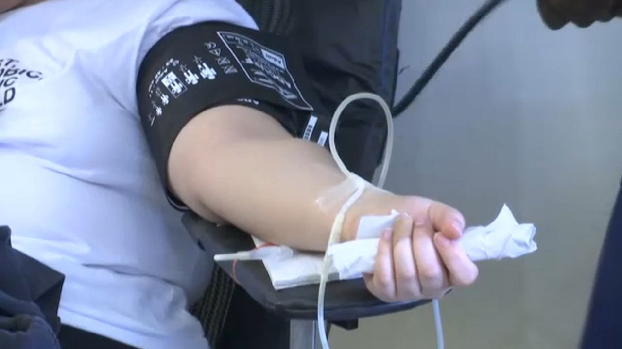 Person donating blood (Spectrum News1)