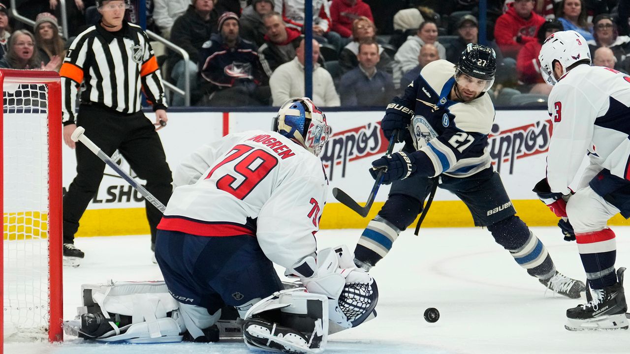 Columbus Blue Jackets center Zachary Aston-Reese (27) shoots against Washington Capitals goaltender Charlie Lindgren (79) in the second period of an NHL hockey game Thursday, Dec. 12, 2024, in Columbus, Ohio. (AP Photo/Sue Ogrocki)