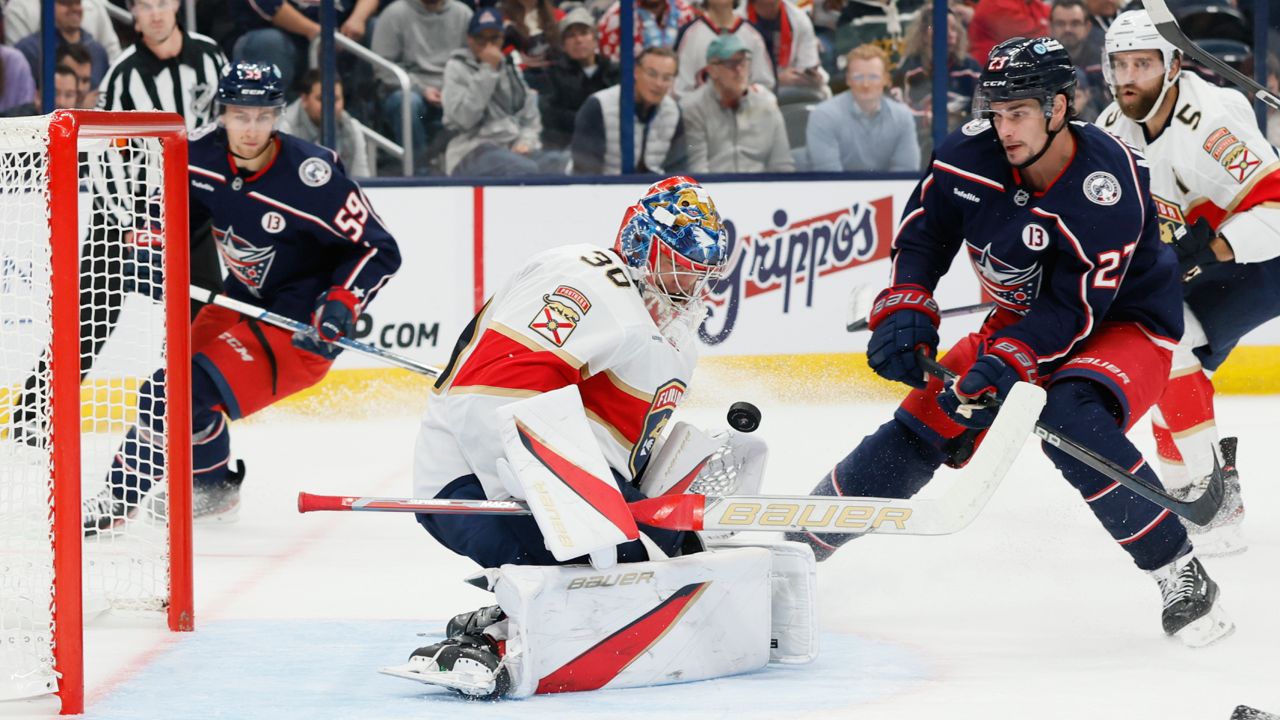 Columbus Blue Jackets' Sean Monahan, right, scores a goal against Florida Panthers' Spencer Knight during the second period of an NHL hockey game Tuesday, Oct. 15, 2024, in Columbus, Ohio.