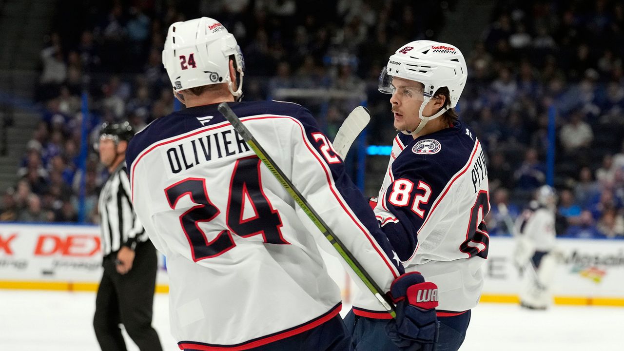 Columbus Blue Jackets left wing Mikael Pyyhtia (82) celebrates his goal against the Tampa Bay Lightning with right wing Mathieu Olivier (24) during the third period of an NHL hockey game Tuesday, Dec. 17, 2024, in Tampa, Fla. (AP Photo/Chris O'Meara)