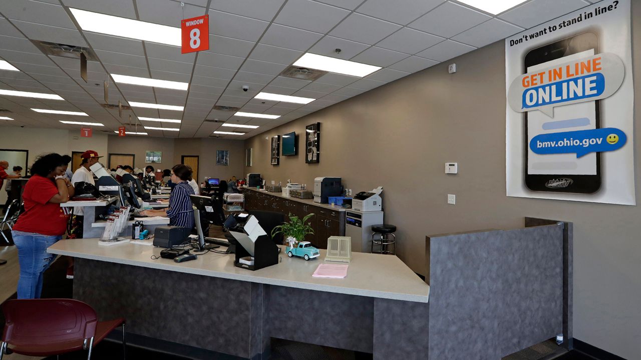 Workers fill customer orders at the Bureau of Motor Vehicles office, Monday, June 17, 2019, in Bedford, Ohio.