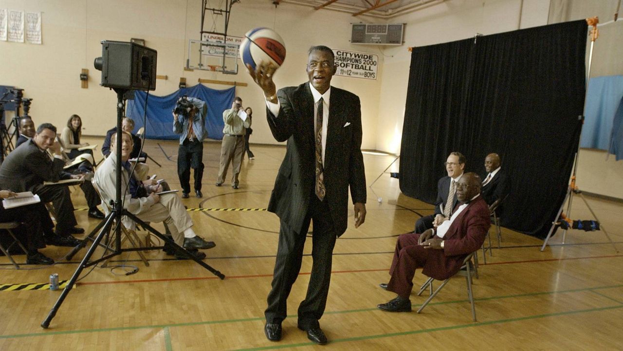 FILE - Former Chicago Bulls player and director of community affairs for the team, Bob Love, shows media members that he hasn't lost his touch with the ball after announcing his candidacy for Alderman in the cities 15th ward, Sept. 25, 2002, in Chicago. (AP Photo/M. Spencer Green, File)