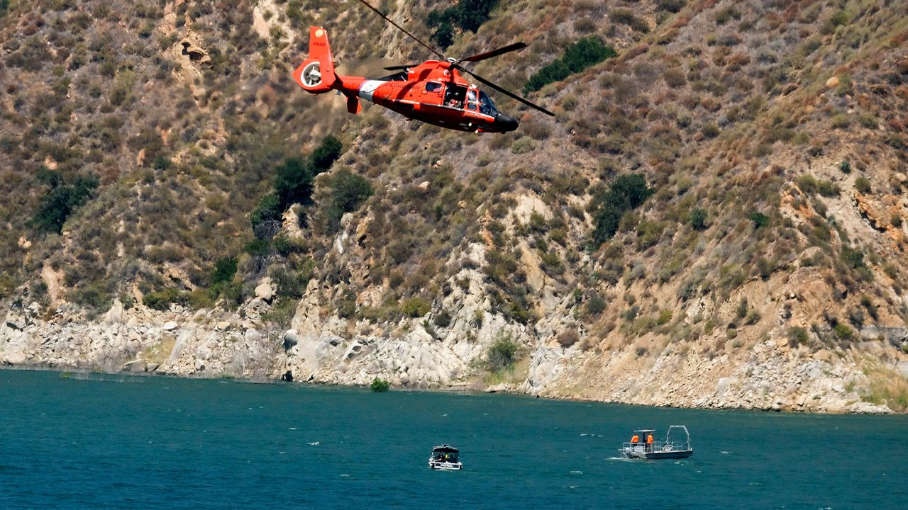 A helicopter helps in the search for former "Glee" star Naya Rivera on Thursday, July 9, 2020, at Lake Piru in Los Padres National Forest, northwest of Los Angeles. (AP Photo/Ringo H.W. Chiu)