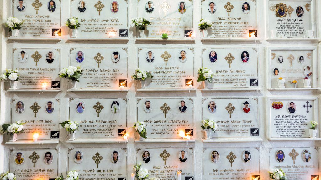 Candles are lit on a memorial wall during an anniversary memorial service at the Holy Trinity Cathedral in Addis Ababa, Ethiopia, March 8, 2020, to remember those who died when Ethiopian Airlines flight ET302, a Boeing 737 Max, crashed shortly after takeoff on March 10, 2019, killing all 157 on board. (AP Photo/Mulugeta Ayene, File)