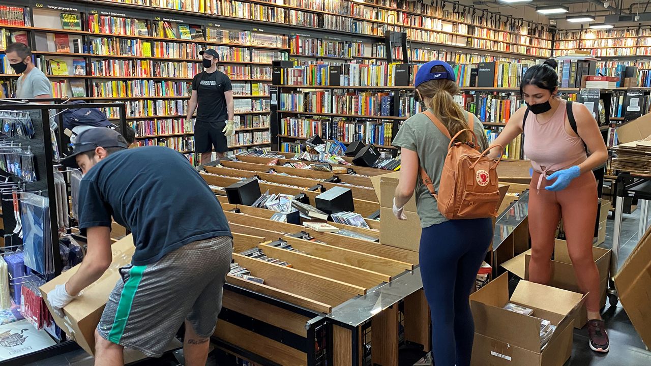 Volunteers help clean up CDs and DVDs at BookMonster in Santa Monica. (Spectrum News/Susan Carpenter)