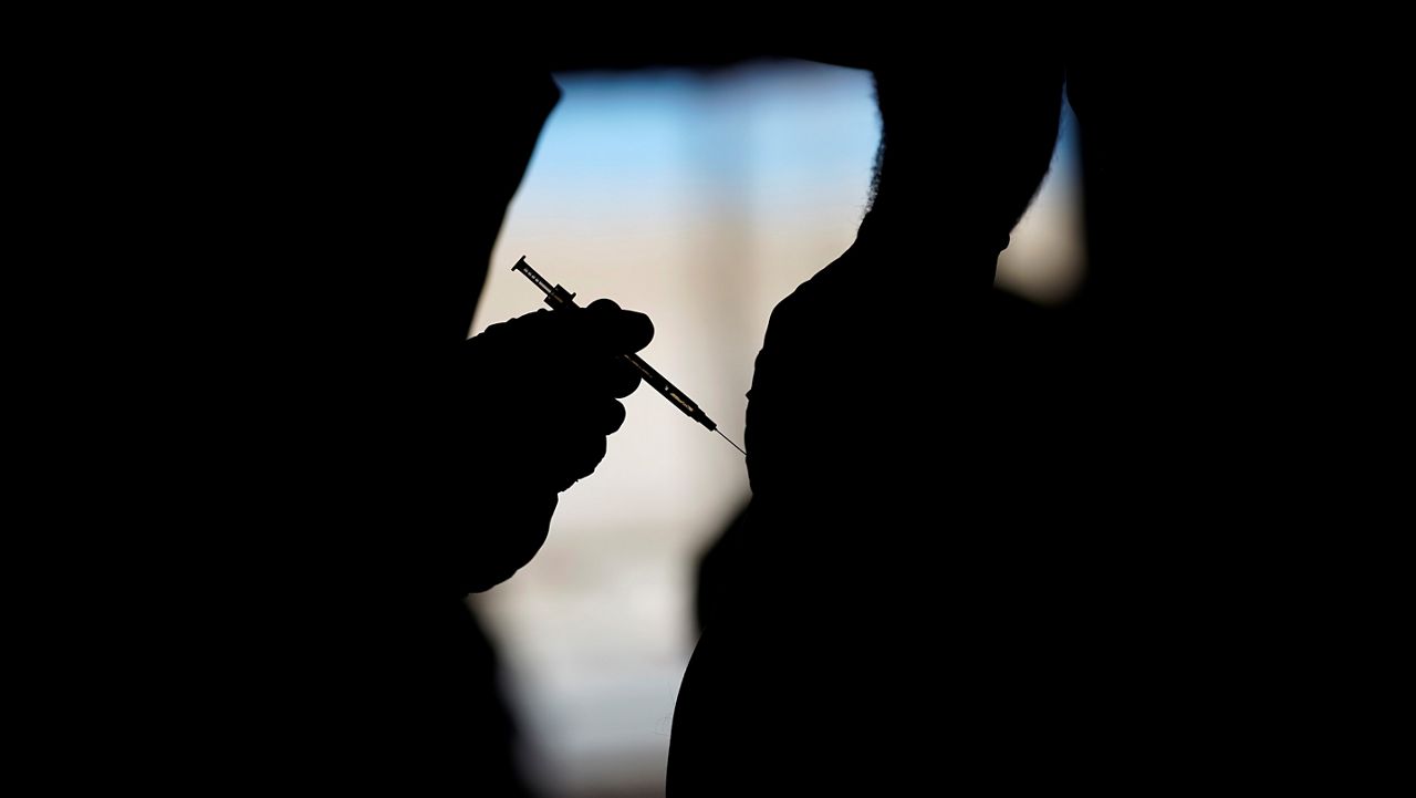 A man receives a COVID-19 vaccine at a vaccination site in Las Vegas. (AP Photo/John Locher)