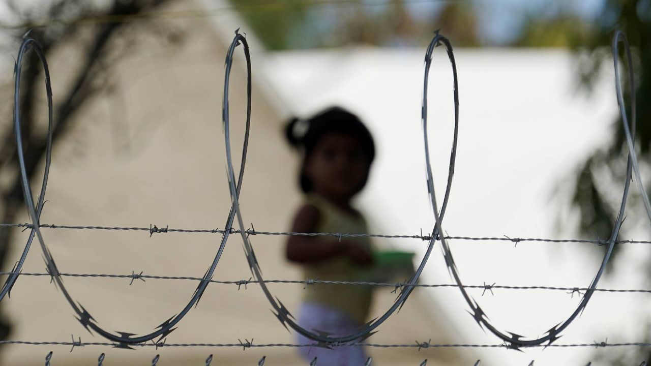 FILE - In this Nov. 18, 2020, file photo, a child plays at a camp for asylum seekers stuck at America's doorstep, in Matamoros, Mexico. (AP Photo/Eric Gay, File)
