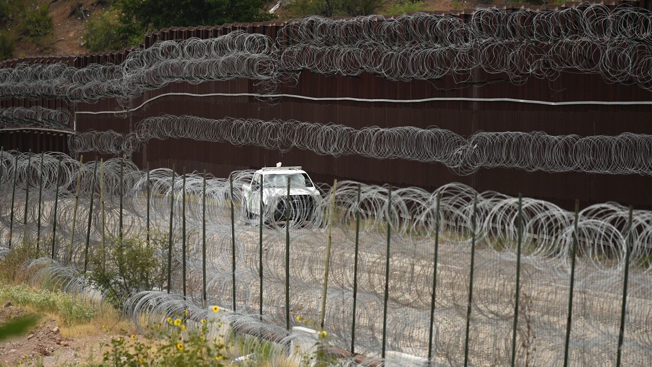 A vehicle drives along the U.S. side of the US-Mexico border wall in Nogales, Ariz., June 25, 2024. (AP Photo/Jae C. Hong, Pool, File)