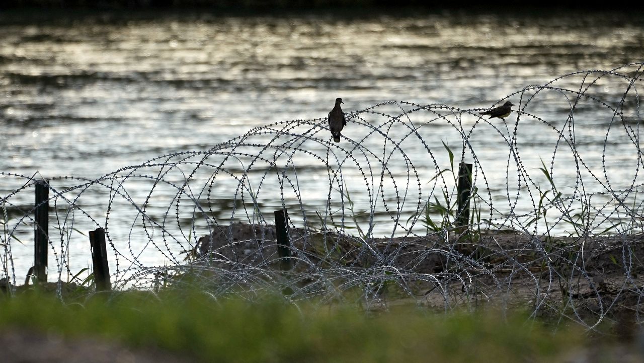 Birds rest on concertina wire along the Rio Grande in Eagle Pass,Texas, July 6, 2023. Texas sued the Biden administration Tuesday, Oct. 24, seeking to stop federal agents from cutting the state's razor wire that has gashed or snagged migrants as they have attempted to enter the U.S. from Mexico at the Rio Grande. (AP Photo/Eric Gay, File)