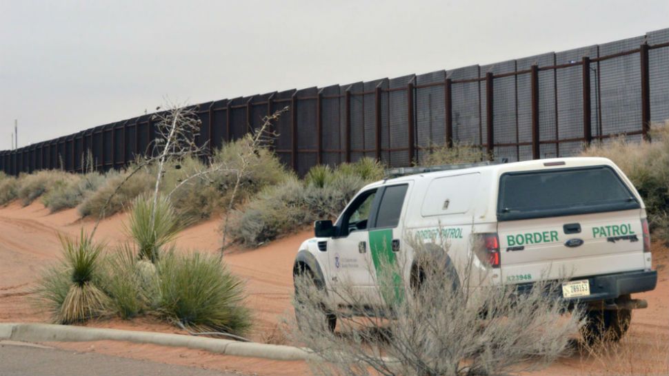 Border wall and patrol car (Spectrum News/File)