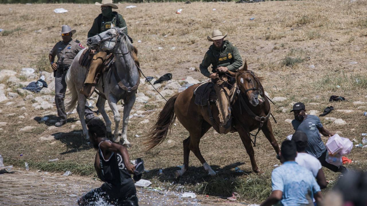 U.S. Customs and Border Protection mounted officers attempt to contain migrants as they cross the Rio Grande from Ciudad Acuña, Mexico, into Del Rio, Texas, Sunday, Sept. 19, 2021. (AP Photo/Felix Marquez)