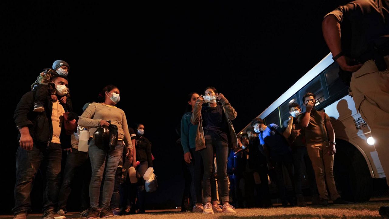 Migrants line up at an intake area after turning themselves in upon crossing the U.S.-Mexico border Tuesday, May 11, 2021, in Roma, Texas. The number of unaccompanied children encountered on the U.S. border with Mexico in April eased from an all-time high a month earlier, while more adults were found coming without families, authorities said Tuesday. (AP Photo/Gregory Bull)