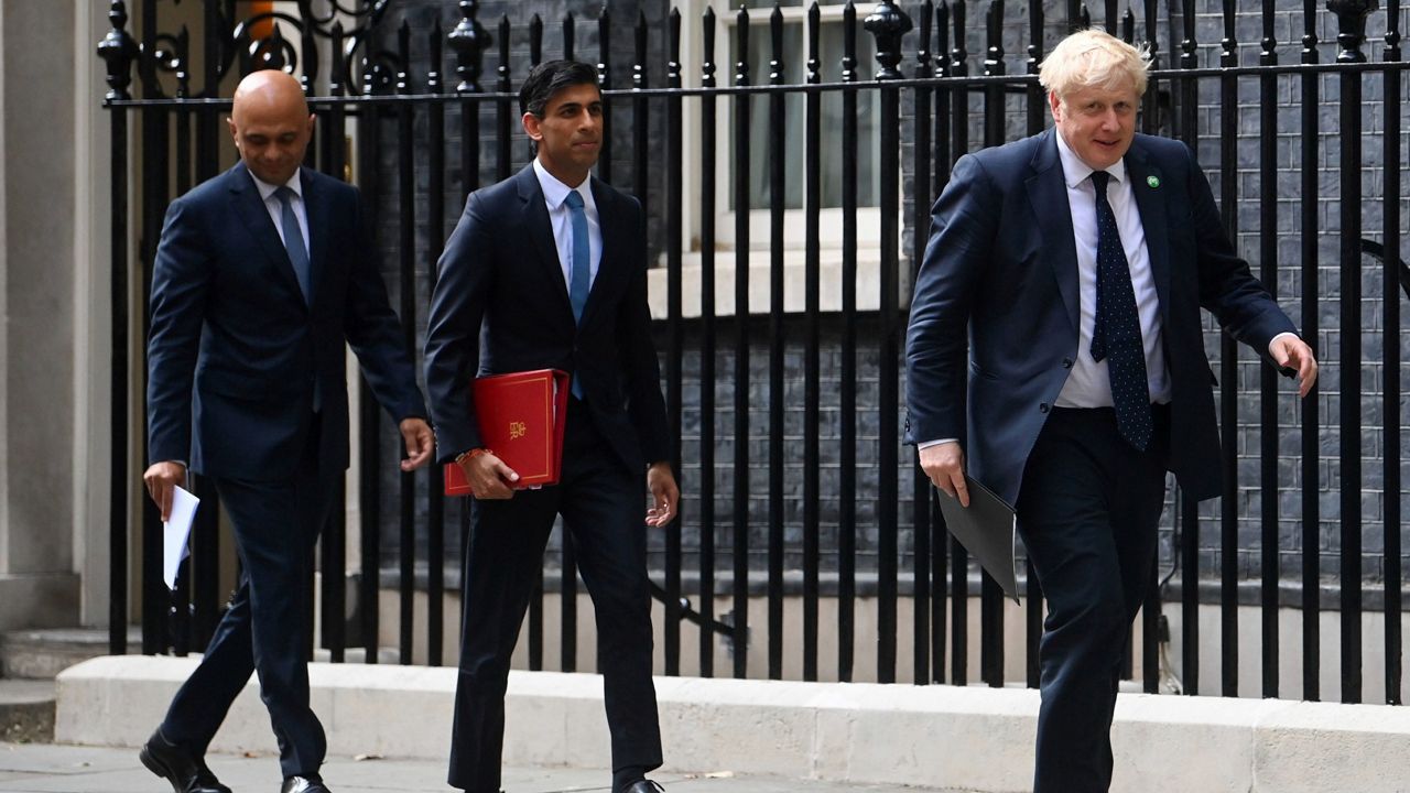 From left, British Health Secretary Sajid Javid, Chancellor of the Exchequer Rishi Sunak and Prime Minister Boris Johnson arrive at No. 9 Downing Street for a media briefing on May 7, 2021. (Toby Melville/PA via AP, File)
