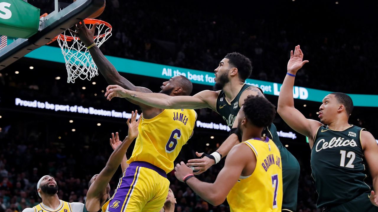 Los Angeles Lakers' LeBron James (6) misses a shot against Boston Celtics' Jayson Tatum, top center, late in the fourth quarter of an NBA basketball game Saturday, Jan. 28, 2023, in Boston. (AP Photo/Michael Dwyer)