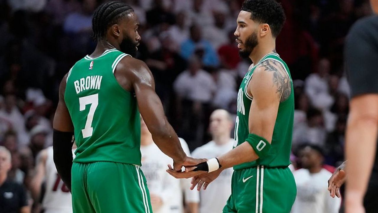 Boston Celtics forward Jayson Tatum (0) and guard Jaylen Brown (7) congratulate each other during the second half of Game 4 during the NBA basketball playoffs Eastern Conference finals against the Miami Heat, Tuesday, May 23, 2023, in Miami. (AP Photo/Wilfredo Lee)