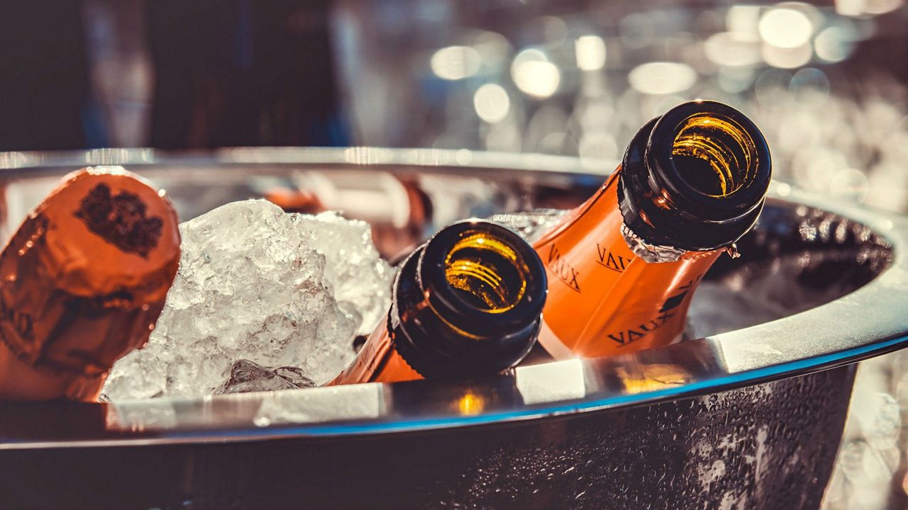 Stock image of champagne bottles on ice. (Pixabay)