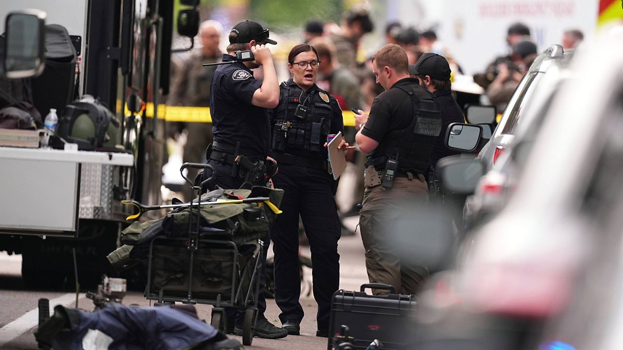 Law enforcement officials investigate after an attack on the Pearl Street Mall Sunday, June 1, 2025, in Boulder, Colo. (AP Photo/David Zalubowski)