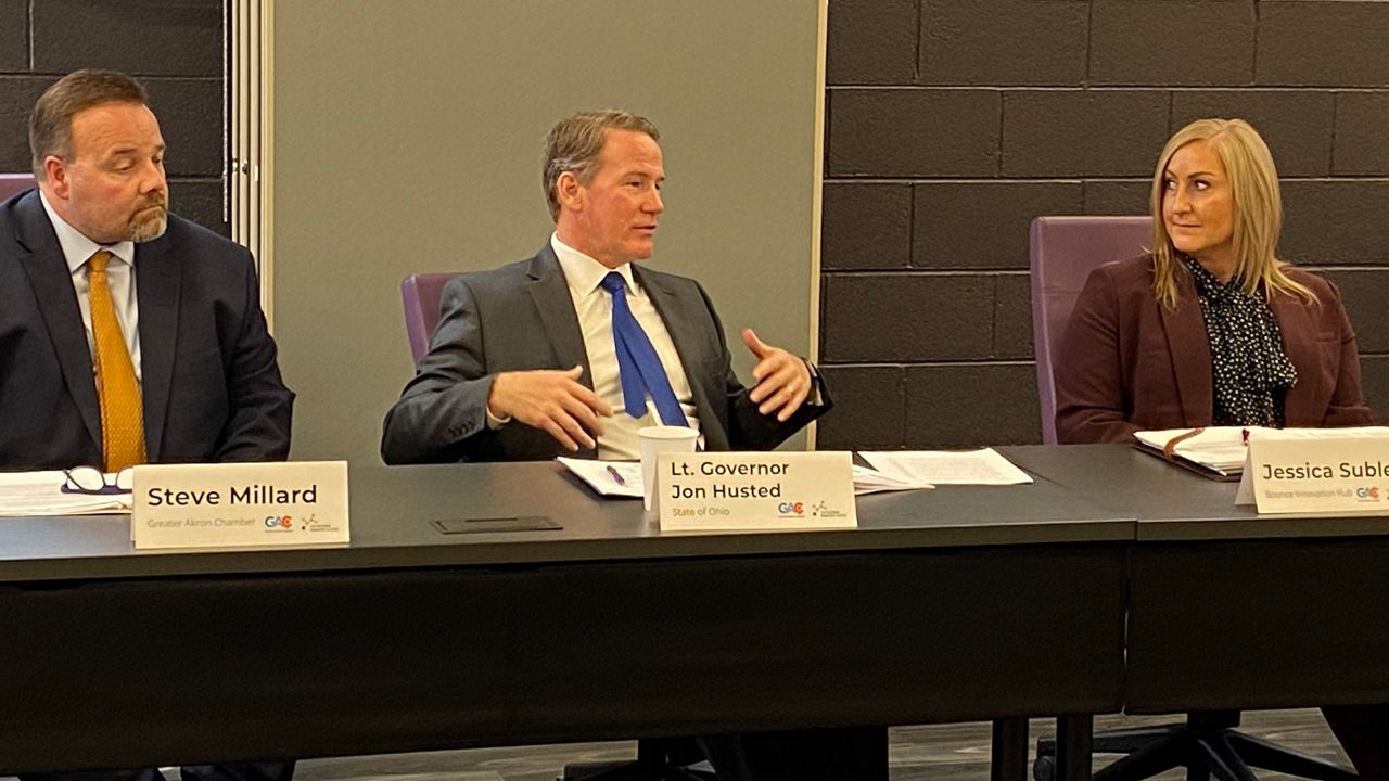 Greater Akron Chamber President and CEO Steve Millard Steve Millard (left) and Bounce CEO Jessica Sublett (right) listen to Lt. Gov. Jon Husted during a roundtable talk at Bounce Innovation Hub in Akron. (Spectrum News/Jennifer Conn)