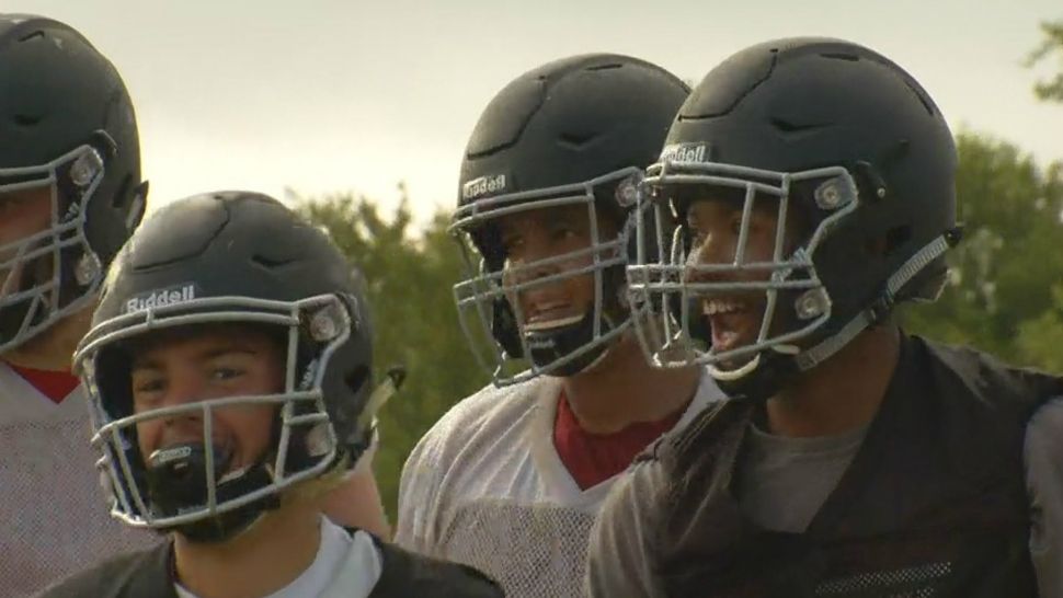 players wearing football helmets