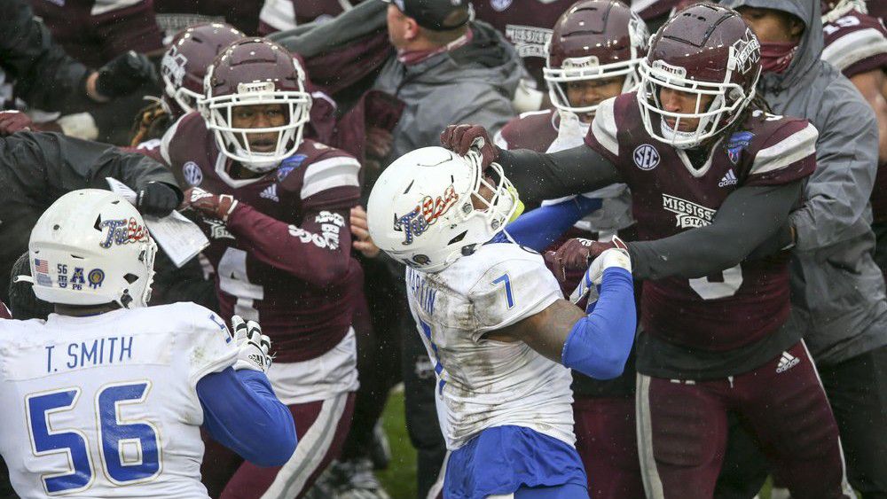 Mississippi State linebacker Aaron Brule (3) hits Tulsa safety TieNeal Martin (7) on the facemask during a postgame fight after Mississippi State's win in the Armed Forces Bowl NCAA college football game in Fort Worth, Texas, Thursday, Dec. 31, 2020. (Ian Maule/Tulsa World via AP)