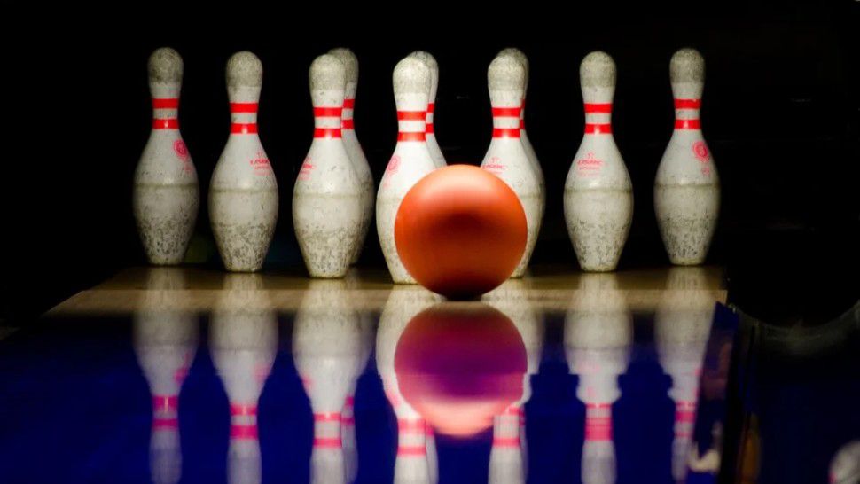 A bowling ball and pins appear in this stock image. (Pixabay)