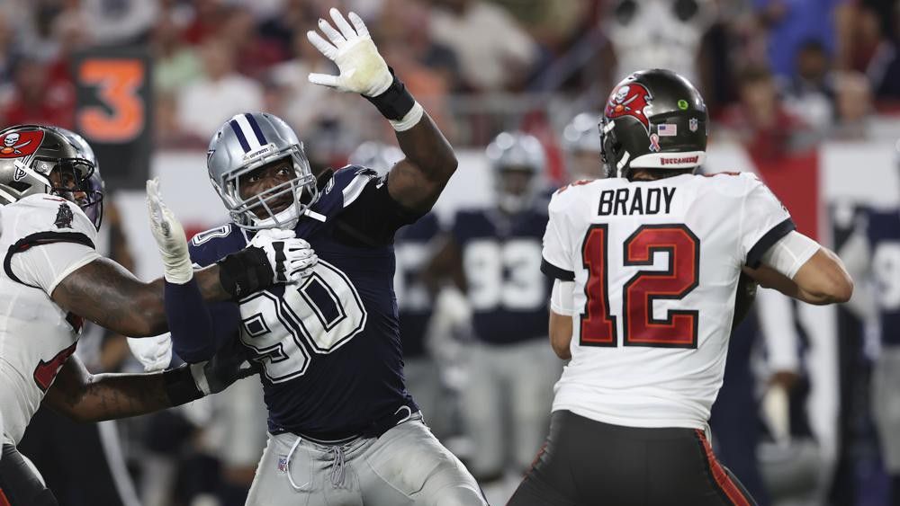 Dallas Cowboys defensive end DeMarcus Lawrence (90) pressures Tampa Bay Buccaneers quarterback Tom Brady (12) during the second half of an NFL football game Thursday, Sept. 9, 2021, in Tampa, Fla. (AP Photo/Mark LoMoglio)