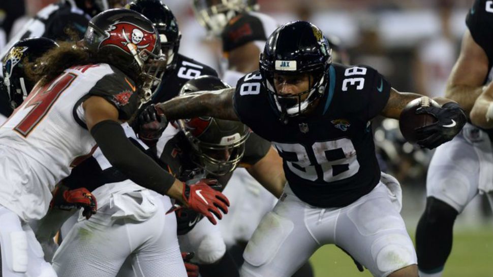 Jacksonville Jaguars running back Brandon Wilds (38) cuts around Tampa Bay Buccaneers cornerback Amari Coleman (44) during the first half of an NFL preseason football game Thursday, Aug. 30, 2018, in Tampa, Fla (AP Photo: Jason Behnken)