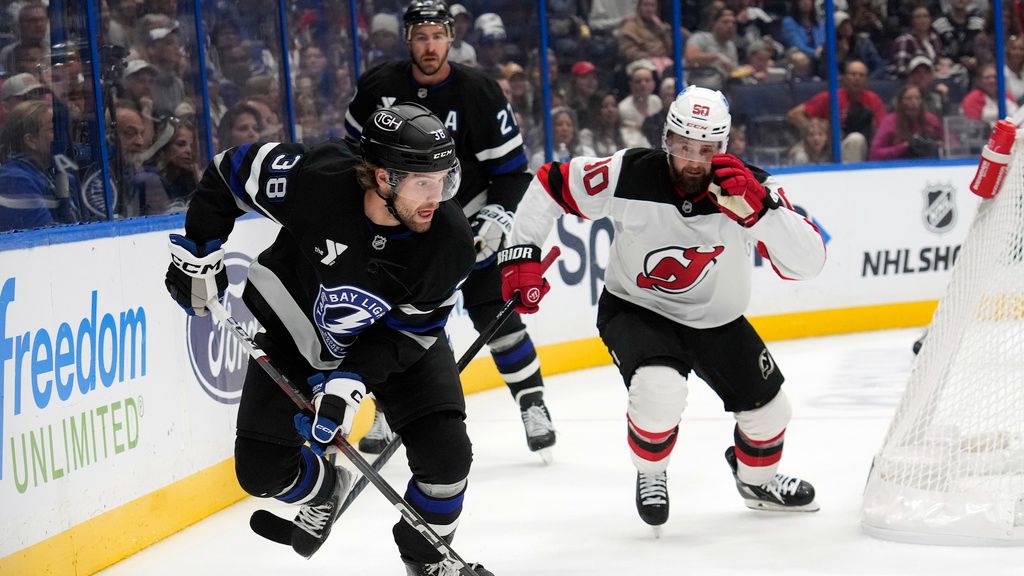 Tampa Bay Lightning left wing Brandon Hagel (38) breaks out ahead of New Jersey Devils left wing Tomas Tatar (90) during the first period of an NHL hockey game Saturday, Nov. 16, 2024, in Tampa, Fla. (AP Photo/Chris O'Meara)