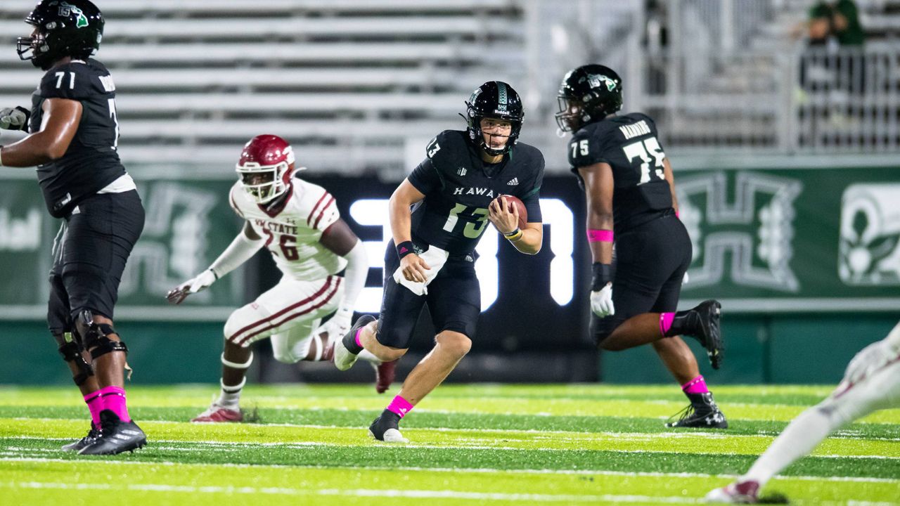 Hawaii quarterback Brayden Schager, seen here running the ball against New Mexico State on Oct. 23, was one of the remaining Rainbow Warriors to participate in the "Braddahhood" movement on social media for solidarity with the program.