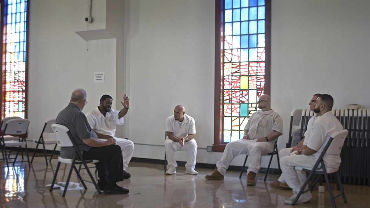 Deaf activist and chaplain Walker Estes sits with hearing-disabled prisoners at the Louisiana State Prison. (Austin Film Society)  